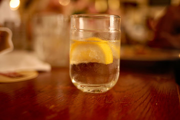 a glass of lemonade stands on a table in a restaurant