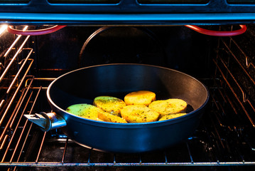 Sliced potatoes in a pan baked in the oven