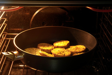 Sliced potatoes in a pan baked in the oven