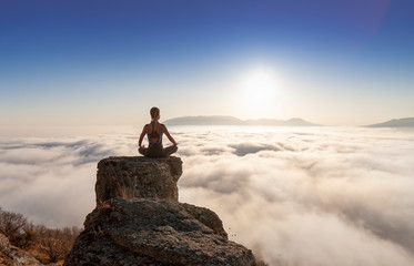 girl practices yoga in the mountains