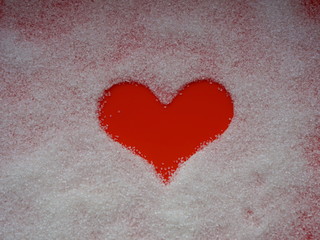 Sweet sugar heart on a red background.