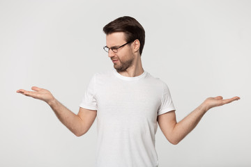 Doubtful Caucasian man make choice hesitating about two options
