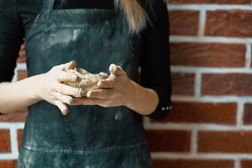 Unrecognisable woman making ceramic bowl in hand. Creative hobby concept. Earn extra money, side hustle, turning hobbies into cash, passion into job, copy space