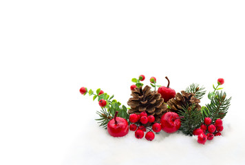 Christmas decoration. Pine natural cones, twigs christmas tree, red berries and red apples on snow with space for text