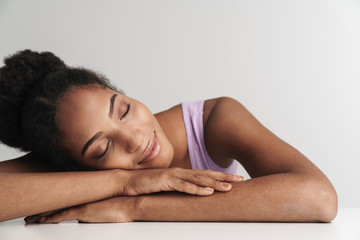 Portrait of african american pleased woman smiling with eyes closed