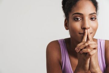 Portrait of african american seductive woman making silence gesture
