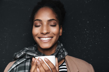 Portrait of african american woman smiling and drinking coffee