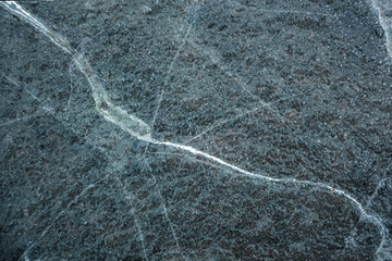 transparent texture of broken ice on red earth with large cracks