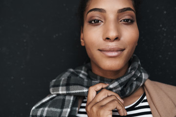 Portrait of african american pleased woman posing and looking at camera