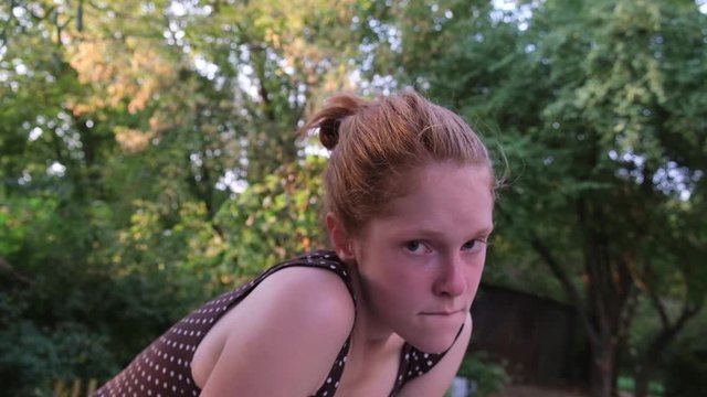Redhead mental handicapped woman want to show something at the backyard.
