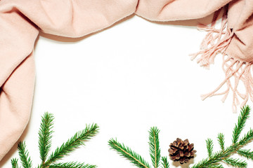 Woolen pink scarf, fir branches and pine cone, winter christmas frame