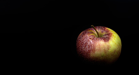 Apple red and yellow on a black background