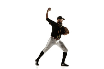 Baseball player, pitcher in a black uniform practicing and training isolated on a white background. Young professional sportsman in action and motion. Healthy lifestyle, sport, movement concept.