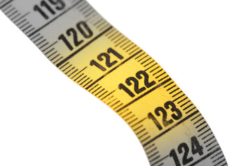 Close-up of a yellow measuring tape isolated on white - 122