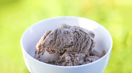 Melting chocolate ice cream in a white ceramic cup