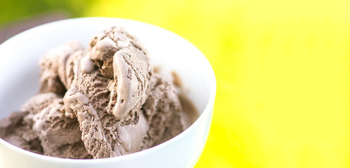 Melting chocolate ice cream in a white ceramic cup