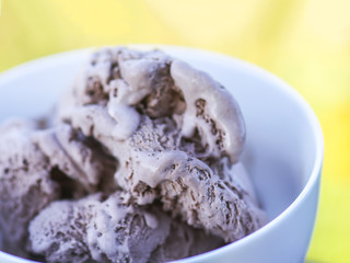 Melting chocolate ice cream in a white ceramic cup