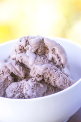 Melting chocolate ice cream in a white ceramic cup