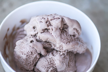 Melting chocolate ice cream in a white ceramic cup