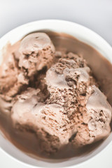 Melting chocolate ice cream in a white ceramic cup