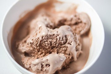 Melting chocolate ice cream in a white ceramic cup