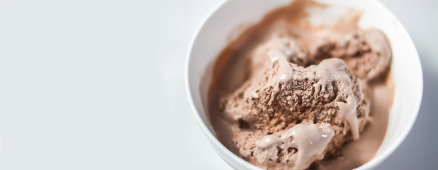 Melting chocolate ice cream in a white ceramic cup