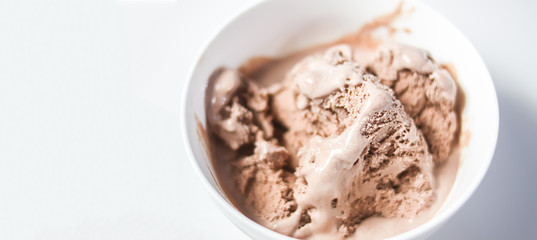Melting chocolate ice cream in a white ceramic cup
