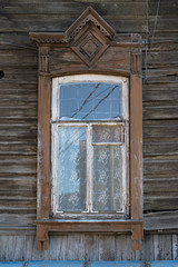Old carved window with shutters