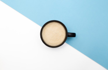 Flatlay coffee in the center of a blue and white background. Diagonal line