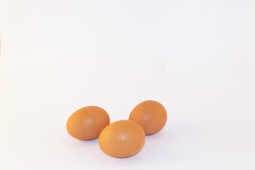 Three chicken eggs isolated on white background. Studio shot