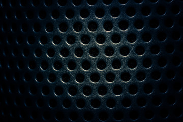Dark navy blue speaker lattice background, close-up