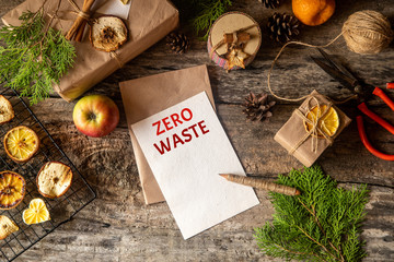 Zero west and eco friendly christmas concept flat lay with gift, branches and candle on rustic...
