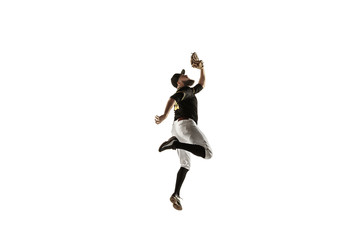 Fototapeta na wymiar In jump. Baseball player, pitcher in black uniform practicing and training isolated on white background. Young professional sportsman in action and motion. Healthy lifestyle, sport, movement concept.