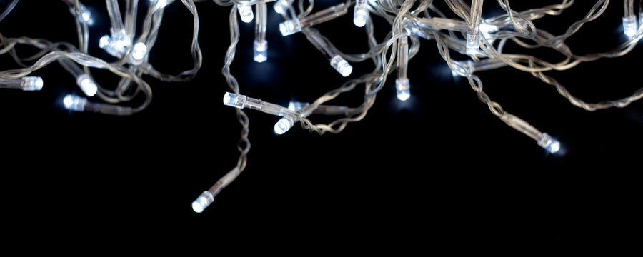 Christmas garland with lights on a black background.