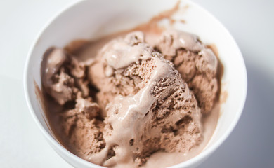 Melting chocolate ice cream in a white ceramic cup