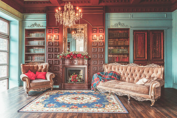 Luxury classic interior of home library. Sitting room with bookshelf, books, arm chair, sofa and...