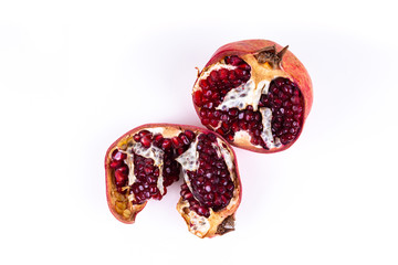 Two halfs of a pomegranate on white background with copy space