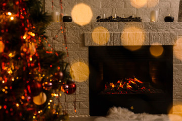 Obraz na płótnie Canvas Christmas tree near fireplace in room