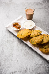 Methi Poori or Puri made using Fresh fenugreek leaves missed with wheat flour, by making small pancake size shapes deep fried in oil, served with tea