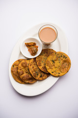 Methi Poori or Puri made using Fresh fenugreek leaves missed with wheat flour, by making small pancake size shapes deep fried in oil, served with tea