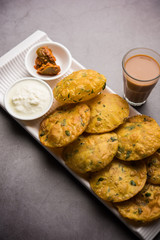 Methi Poori or Puri made using Fresh fenugreek leaves missed with wheat flour, by making small pancake size shapes deep fried in oil, served with tea