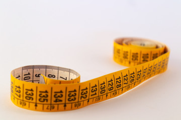 Tailor measuring tapes. Yellow and white sides with numbers showed in centimeters