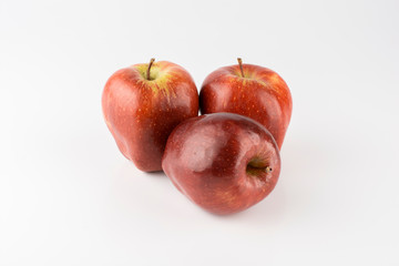 Group of red apples over white background.