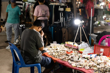 man watching amulets on amulet market