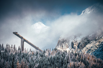 Ski jump and winter mountains in background