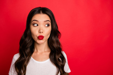 Close-up portrait of her she nice attractive cute lovable glamorous lovely curious funny flirty wavy-haired girl sending you kiss looking aside isolated over bright vivid shine vibrant red color