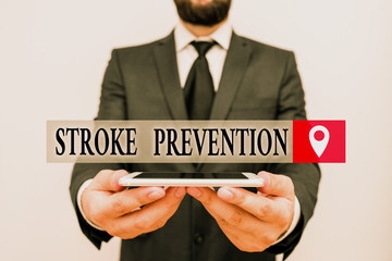Conceptual hand writing showing Stroke Prevention. Concept meaning identified demonstratingal risk factors and change lifestyle Male human wear formal work suit hold smartphone using hand