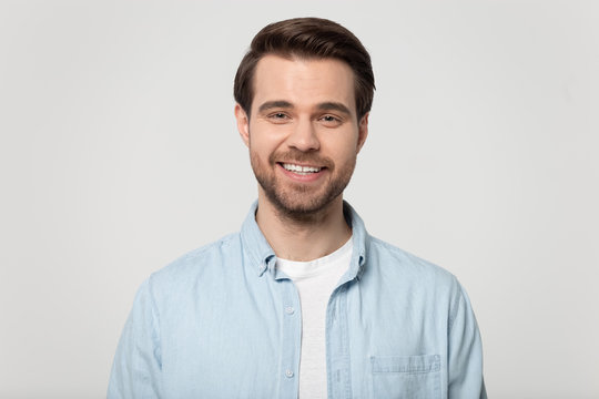 Portrait of smiling Caucasian man posing on grey background