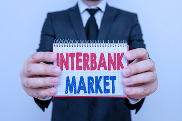 Writing note showing Interbank Market. Business concept for forex market where banks exchange...