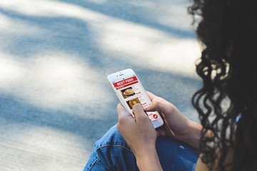 Woman with smartphone ordering take away food